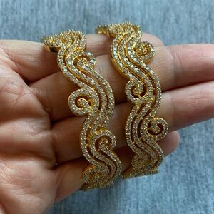A pair of Elegant Gold Women's Bracelets